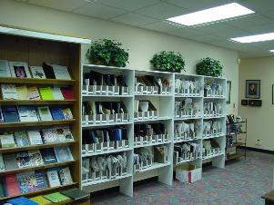 Photo of bookcases in main room holding printed material for recording